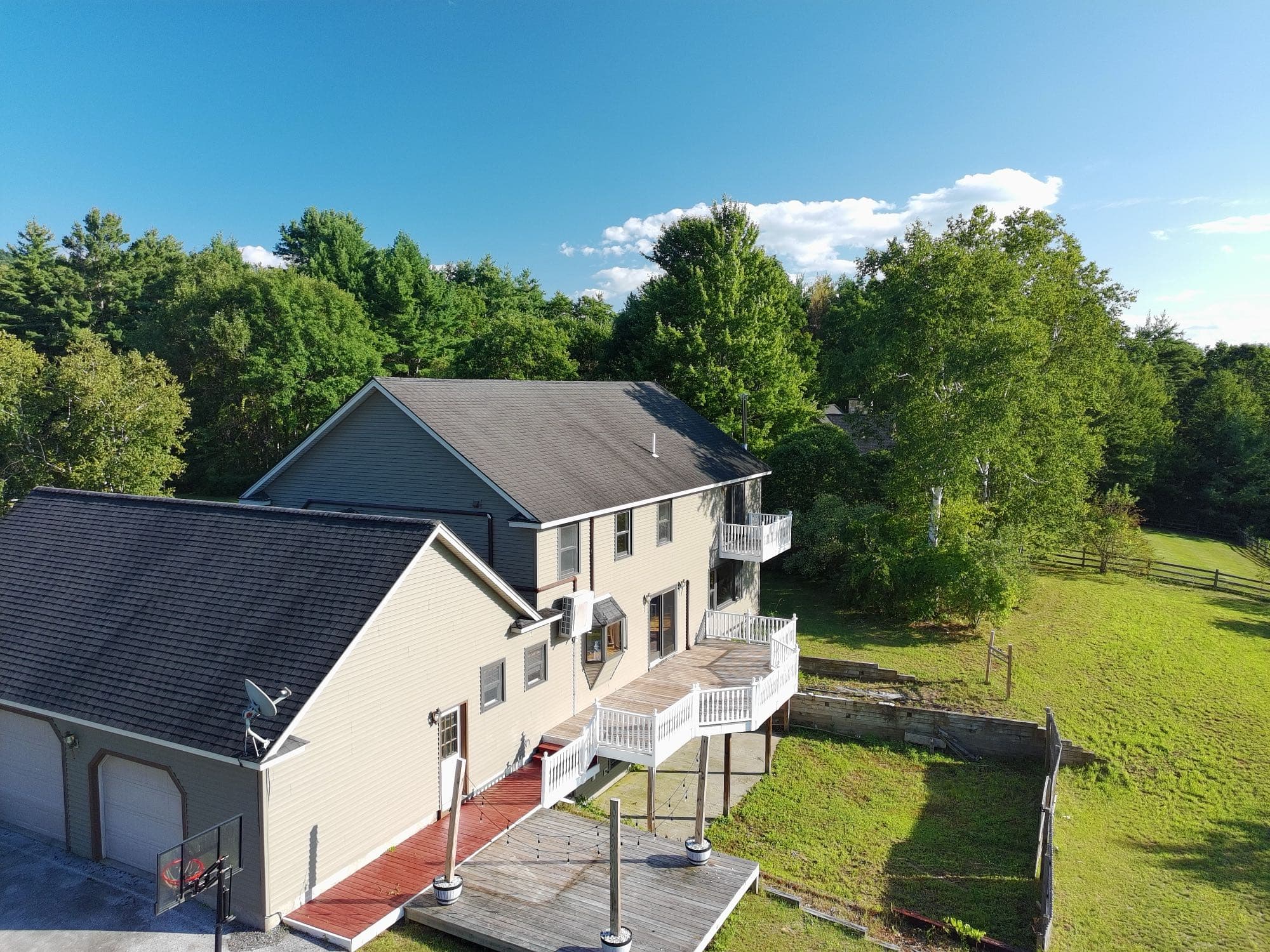 Drone photo of a Rutland County home surrounded by mature trees