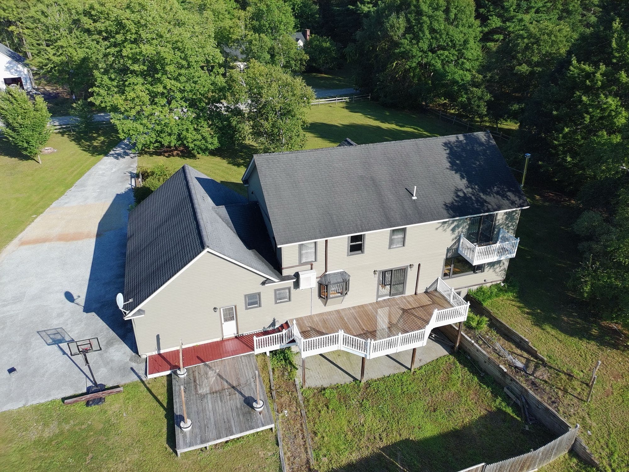 Aerial shot of a property's land, tree line, and open field