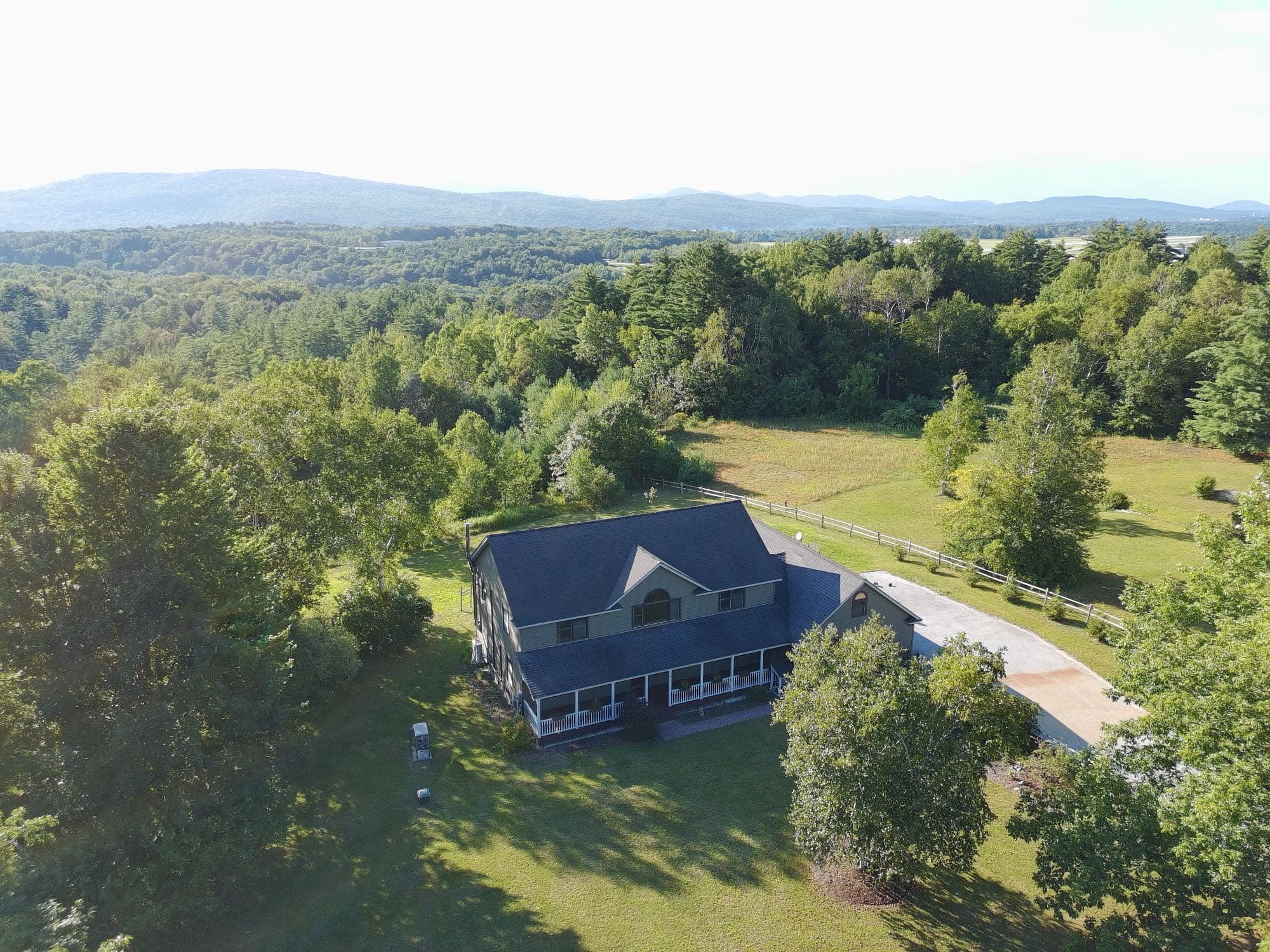 Drone photo of a property's grounds and adjoining pasture