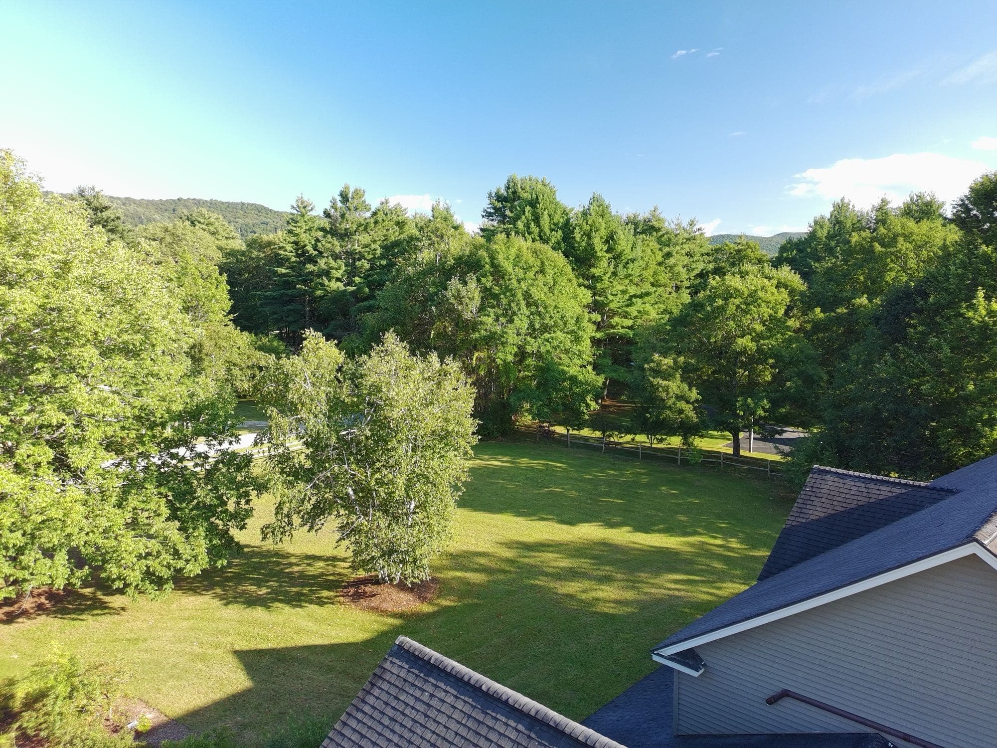 Aerial photo of a residential property framed by Vermont woodland