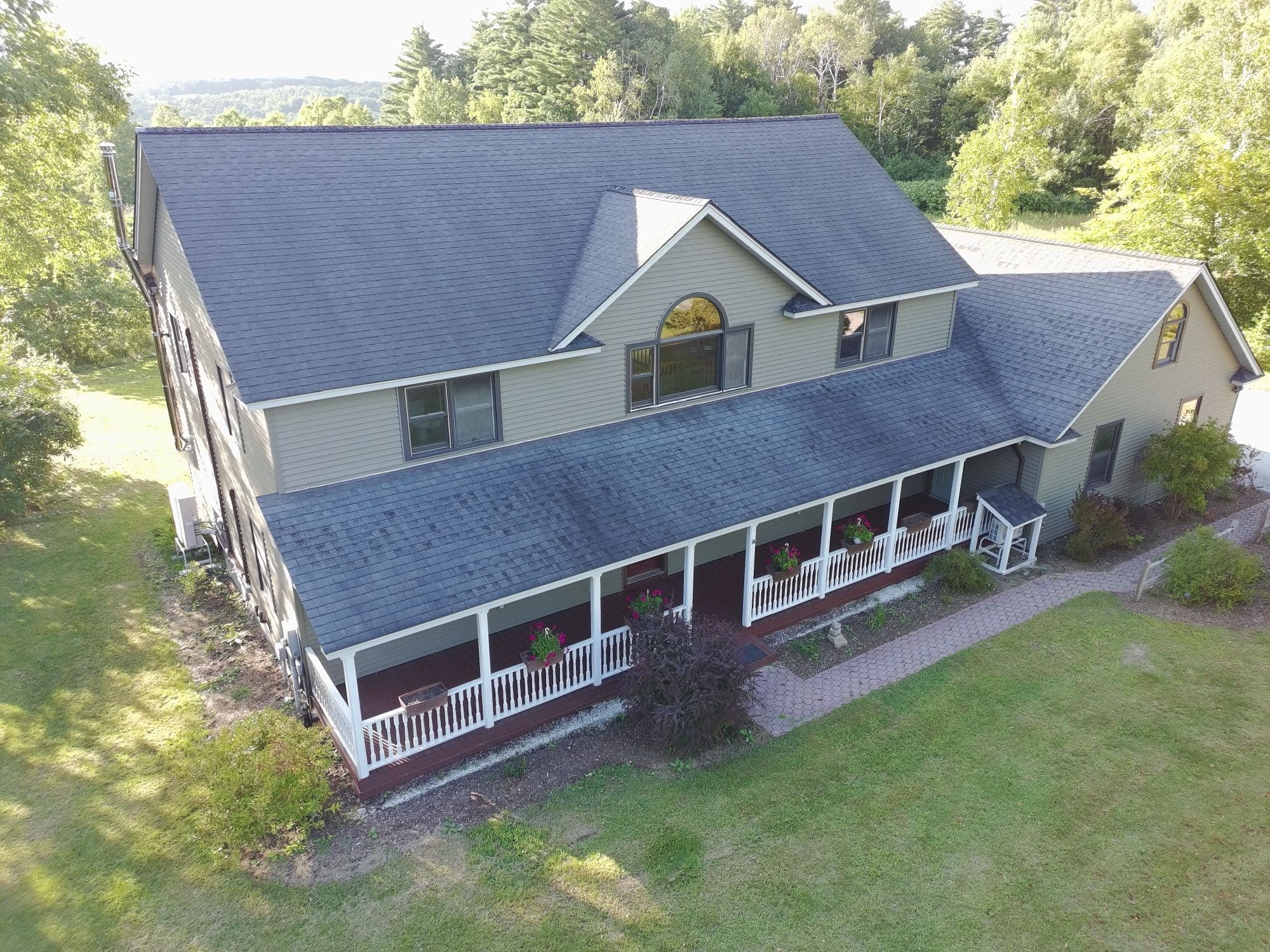 Drone view of a residential property and neighboring fields