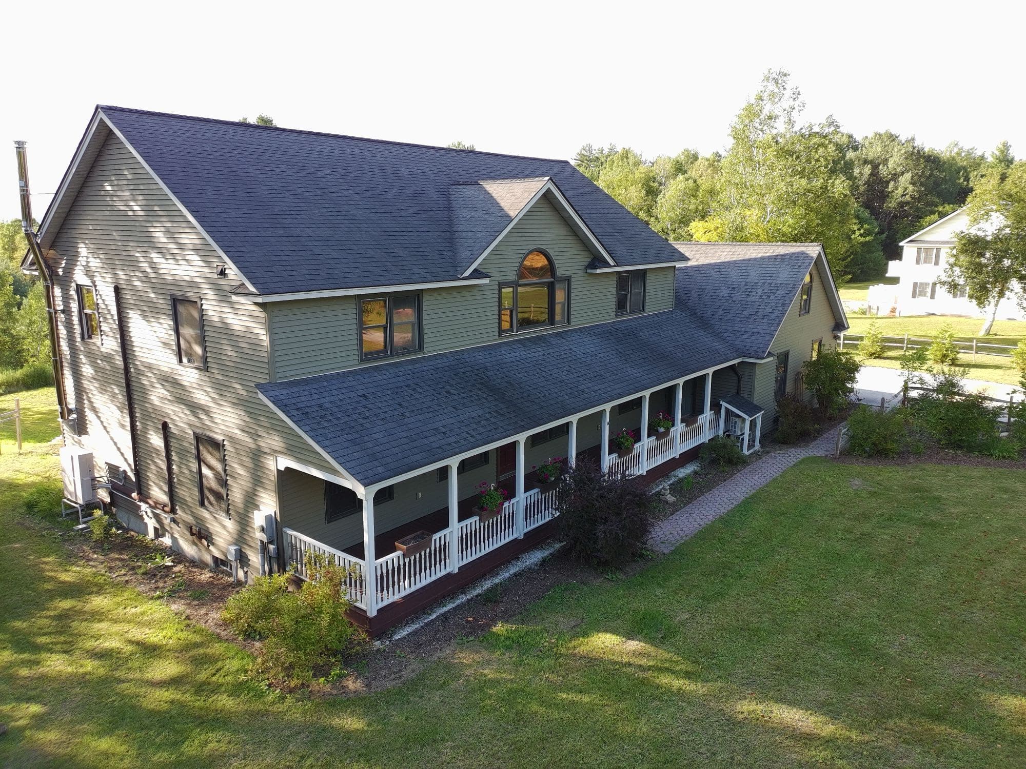 Aerial real estate photo of a home's full exterior and lot
